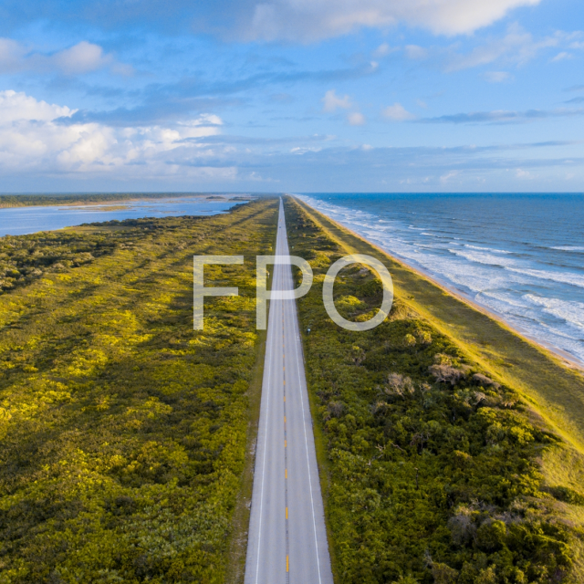 Background image of a road surrounded by water on both sides with text reading FPO on it