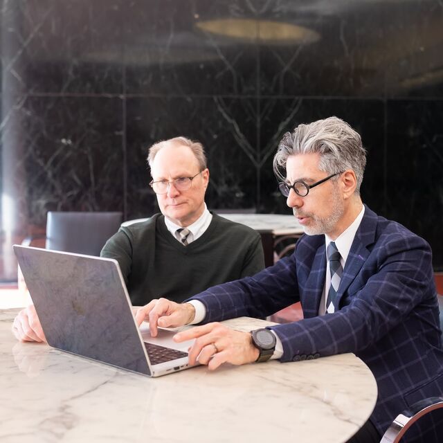 Dr. Sam Volchenboum and Dr. Doug Nordli looking at a laptop