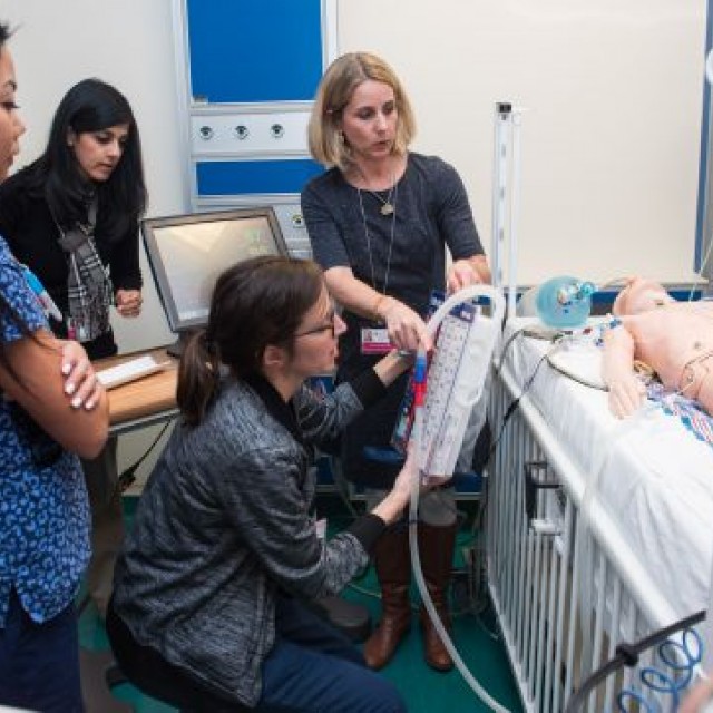 Medical providers doing a PICU simulation training