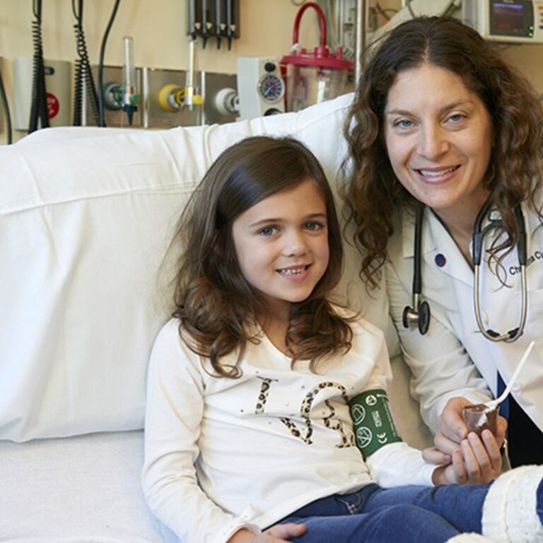 Young patient and Dr. Ciaccio smile at camera